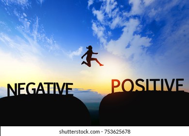 Woman jump through the gap between Negative to Positive on sunset.