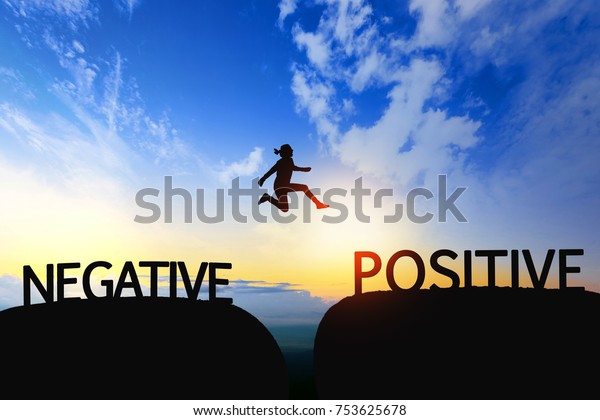 Woman jump through the gap between Negative to\
Positive on sunset.