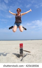 Woman Jumping Off A Pole On The Beach For Joy/ Joy/ Woman Jumping Off A Pole On The Beach For Sheer Joy