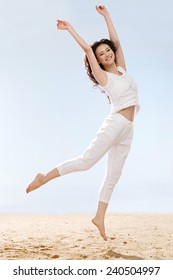 Woman Jumping On Beach