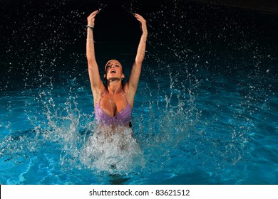 Woman Jumping Out Of The Pool At Night