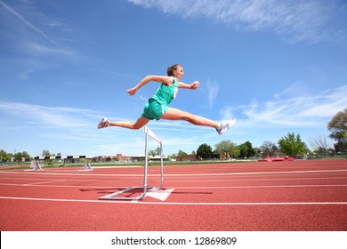 Woman Jumping Over Hurdle