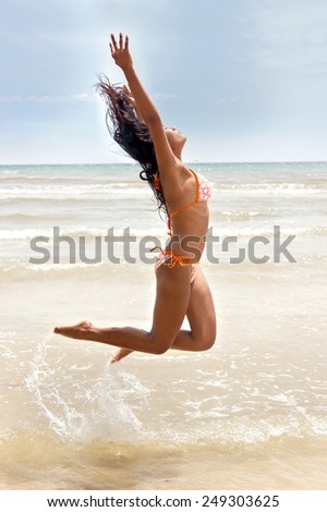 woman jumping in the sea