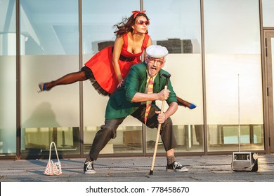 Woman Jumps During A Dance, She Dances With An Old Man.