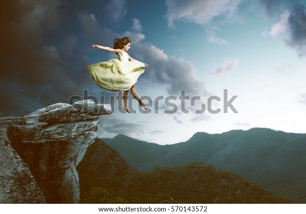 Woman jumps from a high rock