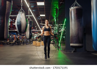 Woman jumps with a skipping rope, boxing training - Powered by Shutterstock