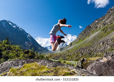 Woman jumps to the sky high in Altai mountains - Shutterstock ID 515151835