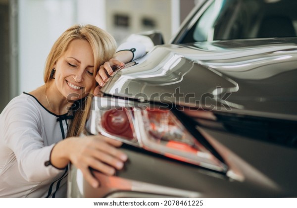 Woman just bought\
her new car in a car\
salon