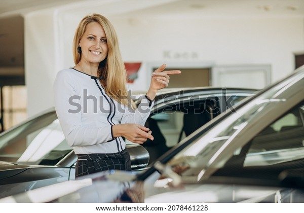 Woman just bought
her new car in a car
salon