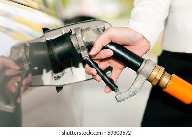 Woman - Just Hand To Be Seen - Refueling Her Car With LPG Gas At A Station