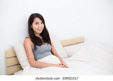 Woman Just Wake Up And Sitting On Bed