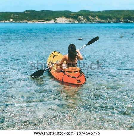 Woman kayaking in a island
