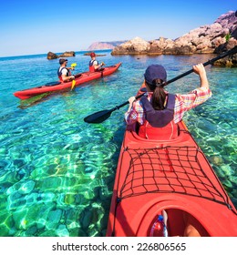 Woman kayaking on the sea with two young men. Canoeing on the islands. - Shutterstock ID 226806565