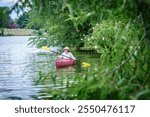 Woman is kayaking on a small lake in Central Kentucky