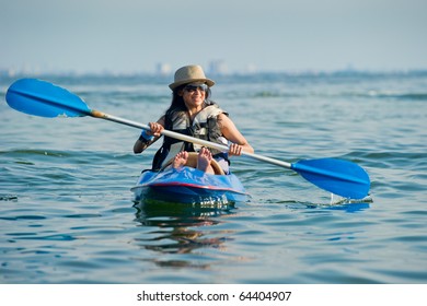 Woman Kayaking In A Tropical Sea