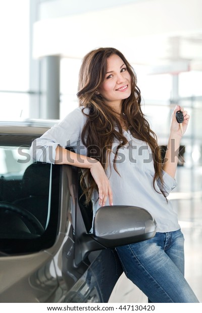 Woman with key\
car.