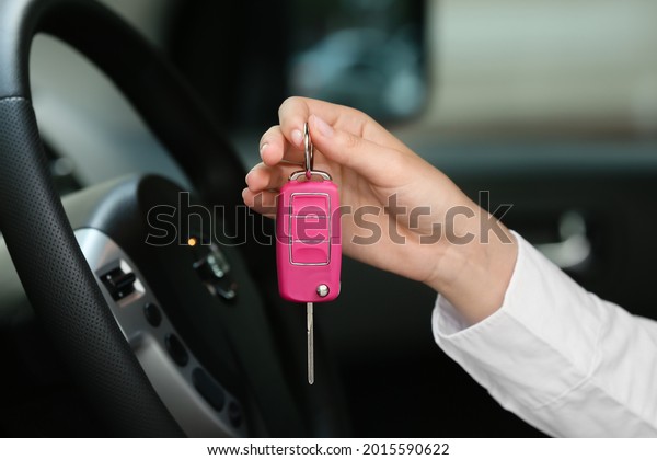Woman with key in car
salon