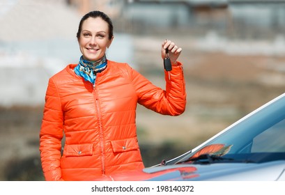 Woman With Keys In Hand Over The Car At Home