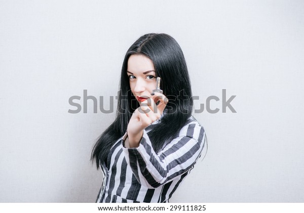 Woman with keys. On a\
gray background.