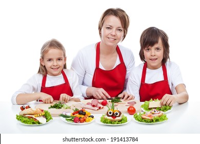 Woman And Kids Making Creative Food Creature Sandwiches Together - Isolated