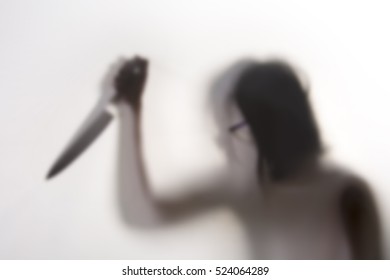 Woman Killer With A Knife In Her Hand Behind A Screen, Blurry Shadow