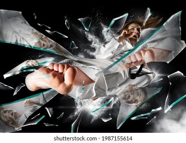 Woman In Kimono Practicing. Fighter Concept. Breaking Glass. Smoke Background