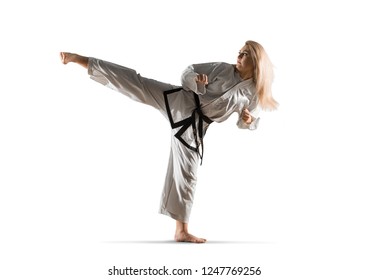 Woman In Kimono Practicing Taekwondo. Isolated On White Background