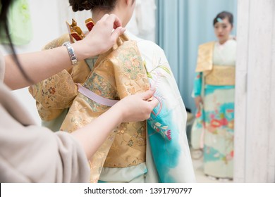 Woman In A Kimono(The Girls Prepare A Kimono Known As Furisode For Their Coming Of Age Ceremony.)