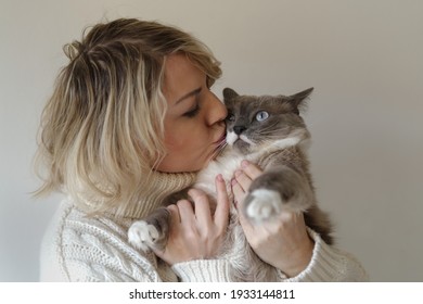 Woman Kisses Her Siamese Cat