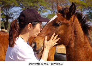 Woman Kissing Her Foal With Love