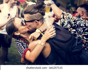 Woman Kissing Man in Live Music Concert Festival - Powered by Shutterstock