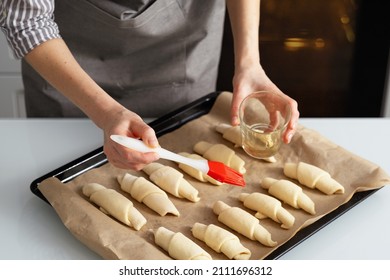 A Woman Is In The Kitchen Baking Bagels With Jam. Sweet Pastry With Your Own Hands.

