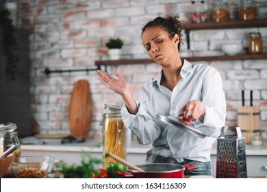 Woman In Kitchen. Beautiful Mixed Race Woman Burned Meal. 