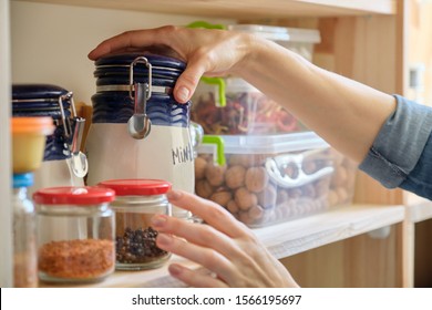 Woman In The Kitchen With Can Of Dry Mint, Food Storage, Pantry.