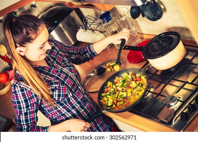 Woman In Kitchen Cooking Stir Fry Frozen Vegetables. Girl Frying Making Delicious Dinner Food Meal. Instagram Filtered.