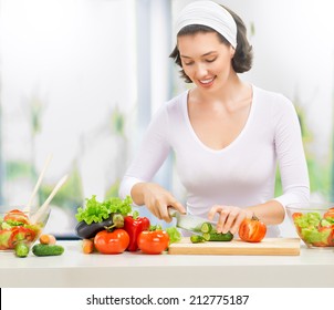 Woman In Kitchen Making Salad