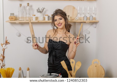 Woman in the kitchen with a rolling pin.