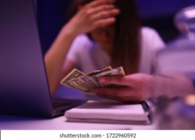 Woman in kitchen is sad and counts money that ended at wrong time closeup background. Unemployment due to a viral pandemic corona virus concept. - Shutterstock ID 1722960592
