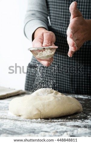 woman kneading bread dough with her hands