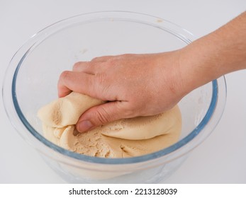 A Woman Kneading Dough In A Bowl. Close Up.