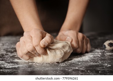 Woman Kneading Dough On Table