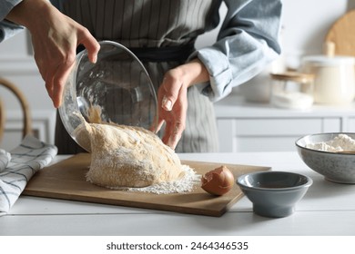 Woman kneading dough at white wooden table in kitchen, closeup - Powered by Shutterstock