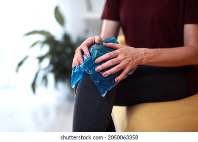 Woman With Knee Pain Injury At Home Using Ice Gel Pack.