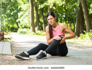 Woman With Knee Pain In A Park