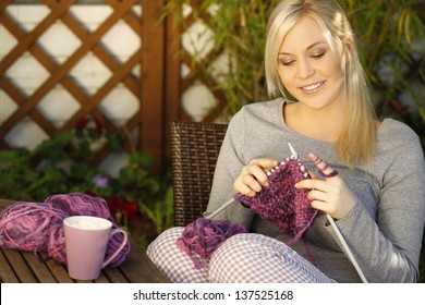 Woman Knitting On Terrace