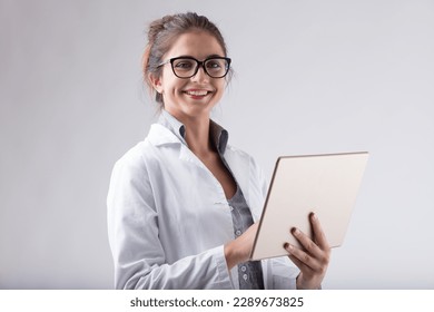 woman, lab coat, glasses, digital tablet, smiling, positive news, scientific, technology, modern technology, data analysis, research, knowledge, expertise, precision, technical skills, high-tech tools - Powered by Shutterstock