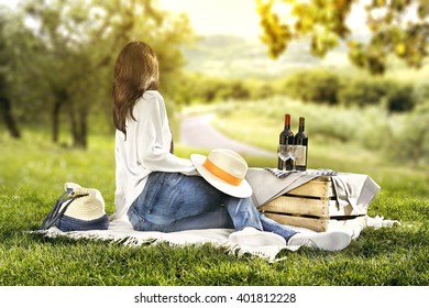 woman and landscape and bottles of red wine 