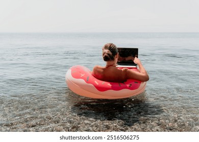 Woman Laptop Beach Working Remotely on Inflatable Float - Powered by Shutterstock