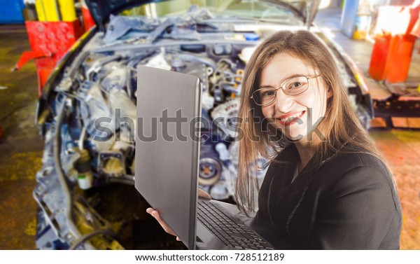woman with laptop and broken car in background, auto\
service concept    