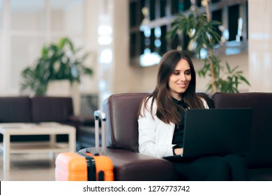 Woman with Laptop and Luggage in Airport Waiting Room. Happy businesswoman reading her emails on the go
 - Powered by Shutterstock